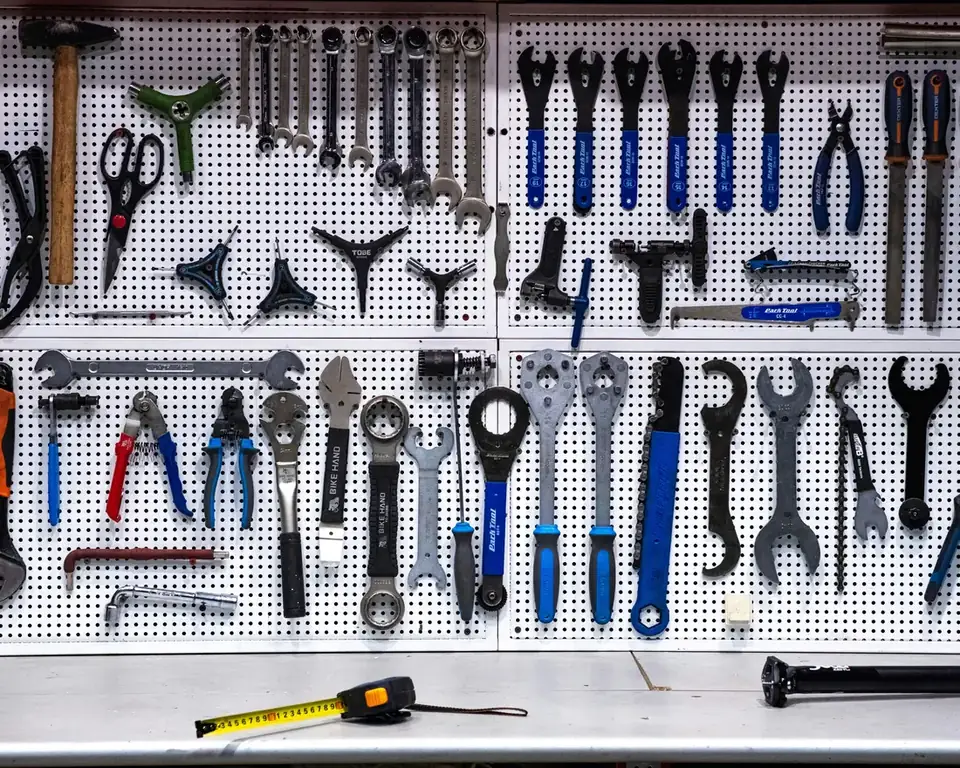 A wall of hand tools including spanners, pliers and screwdrivers