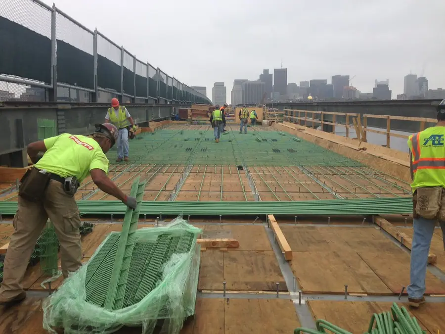 Workers tying steel reinforcement bars on site