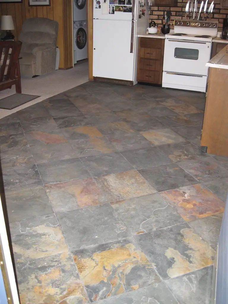 A kitchen floor laid with slate tiles